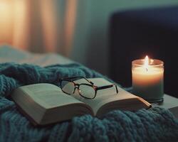 Cozy Nighttime Reading Scene with Open Book Glasses and Candlelight photo