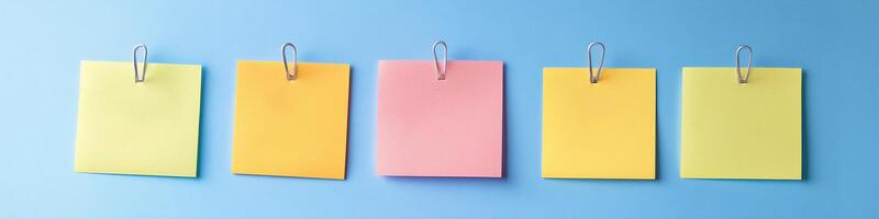 Colorful sticky notes arranged on blue background for reminders and creative planning photo