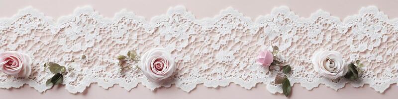 Delicate white lace banner with blush roses on a soft pastel pink background photo