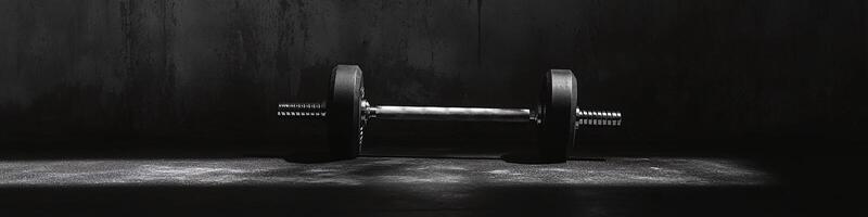 Dumbbell on Ground with Dark Background and Copy Space photo