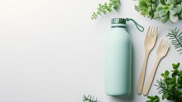Top Down View of Reusable Water Bottle and Miniature Potted Plants on White Background photo