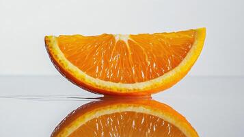 Close Up of Orange Slice on Wet Surface with White Background photo