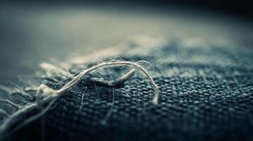 Single Thread Unraveling from Linen Cloth Close Up photo