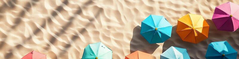 Bird's-Eye View of Colorful Umbrellas on Sandy Beach photo