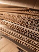 Close-up view of stacked corrugated cardboard layers, showcasing the intricate wave structure and texture, ideal for concepts like packaging, recycling, industry, and material design photo