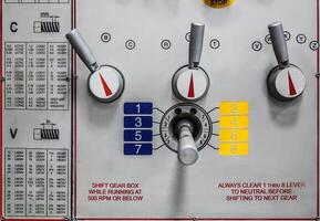 A control panel with various levers, dials, and detailed settings for gear shifting and threading. photo