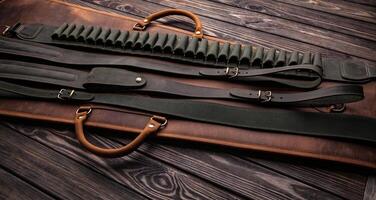 A set of leather rifle slings and a cartridge belt with bullet loops, laid out on a wooden surface, showcasing craftsmanship and durability. photo