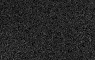 A close-up of a black textured surface, showcasing detailed patterns and uniform color, perfect for backgrounds. photo