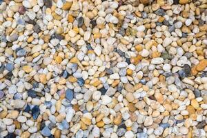 Colorful River Pebbles Background.A Vibrant Collection of Smooth Stones in Various Shades and Sizes photo
