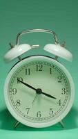 Vertical time lapse of a clock time passing over a day to night on green background. video