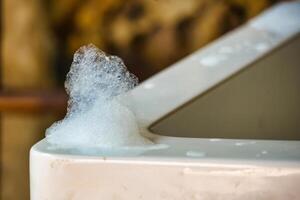 Close-Up of Soap Bubbles on the Edge of a Jacuzzi Tub, Capturing a Relaxing and Serene Atmosphere for an Indulgent Bathing Experience in a Luxurious Setting photo