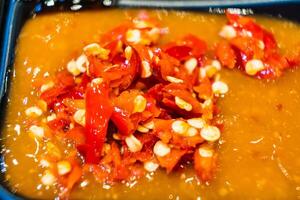 Close-Up of Freshly Chopped Red Chili Peppers in a Tangy Sauce - Perfect for Spicy Food Lovers photo