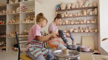Young artisans create pottery at a workshop in a creative studio setting video