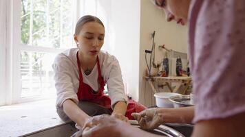 Young artist learns pottery techniques during workshop in creative studio video