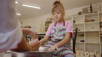 girl learns pottery techniques during a workshop in a creative studio video
