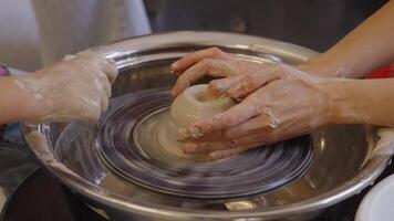 Learning pottery techniques at a pottery studio in a creative workshop video