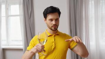 Man discusses drinking habits while holding a glass of water in a cozy room video