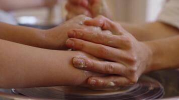 Hands unite to shape clay in a pottery class during the afternoon session video