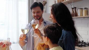Friends celebrate together with drinks in a cozy kitchen setting video