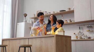 Family celebration with cake and drinks in a modern kitchen setting video