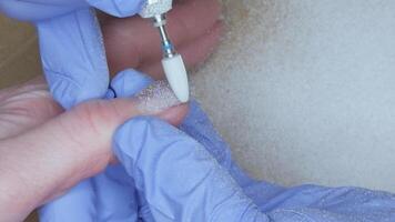 Removing old nail polish using power tool. Close-up. video