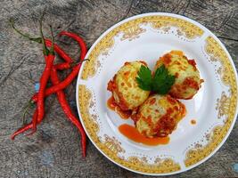 Egg Balado. Balado is a type of hot and spicy bumbu spice mixture found in Indonesian cuisine. Balado sauce is made by stir frying ground red hot chili pepper with other spices photo