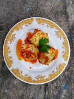 Egg Balado. Balado is a type of hot and spicy bumbu spice mixture found in Indonesian cuisine. Balado sauce is made by stir frying ground red hot chili pepper with other spices photo