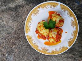 Egg Balado. Balado is a type of hot and spicy bumbu spice mixture found in Indonesian cuisine. Balado sauce is made by stir frying ground red hot chili pepper with other spices photo