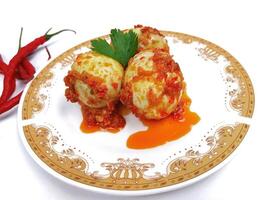 Egg Balado. Balado is a type of hot and spicy bumbu spice mixture found in Indonesian cuisine. Balado sauce is made by stir frying ground red hot chili pepper with other spices photo
