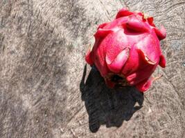 Dragon fruit isolated on wooden background photo