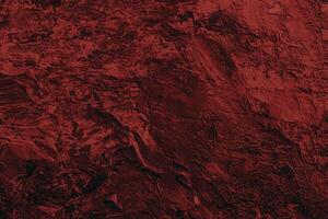 Abstract textured artwork featuring deep red hues and intricate, rough brushstroke patterns for a dramatic effect. photo