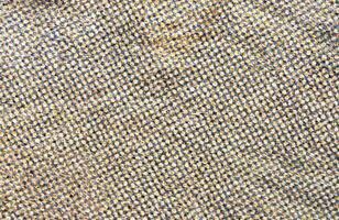 Detailed close-up of textured fabric showcasing intricate weave patterns in neutral tones. photo