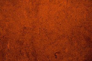 A rustic orange wall with a rough, fibrous texture, perfect for natural or vintage design backgrounds. photo