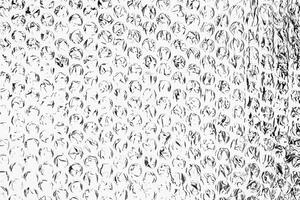 High contrast black and white bubble wrap texture with abstract circular patterns, perfect for creative backgrounds. photo