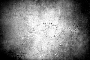 A black and white grunge texture with scratches, cracks, and a distressed appearance, suitable for backgrounds. photo