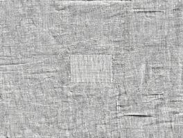 Close-up of wrinkled linen fabric texture with a fine weave pattern, ideal for backgrounds, design, and textile projects. photo