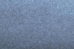 Gray textured paper background with fine fibers and subtle grain patterns, ideal for design or text overlays. photo