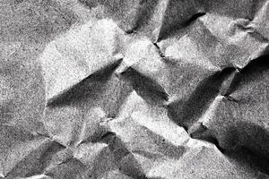 High-contrast crumpled paper texture in black and white with creases and shadows photo