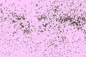 Scattered abstract brown particles on a pink background, creating a unique artistic texture. photo