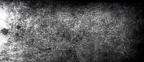 Abstract dark textured surface with subtle scratches, stains, and high contrast details. photo