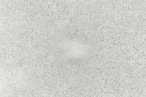 A seamless white speckled texture with a rough, granular pattern, ideal for design and graphic overlays. photo