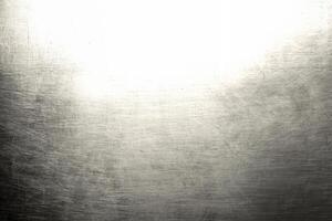 Close-up of a brushed metal texture with a subtle light gradient, ideal for backgrounds, industrial, or design projects. photo