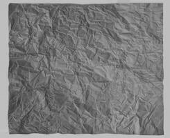 Wrinkled gray paper texture with realistic creases, ideal for backgrounds, design elements, or overlay effects. photo