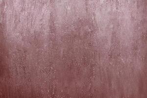 A close-up view of a rusty metal surface with a textured and weathered appearance in reddish-brown tones. photo