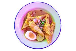Top view of Spicy and sour pork noodle with boil egg, focus selective photo