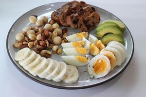 walnut cranberry sourdough bread or cranberry sourdough with boiled egg , avocado , banana and nuts photo