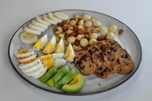 walnut cranberry sourdough bread or cranberry sourdough with boiled egg , avocado , banana and nuts photo
