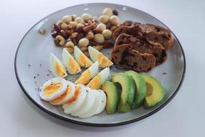 walnut cranberry sourdough bread or cranberry sourdough with boiled egg , avocado and nuts photo