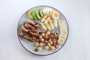 walnut cranberry sourdough bread or cranberry sourdough with boiled egg , avocado , banana and nuts photo