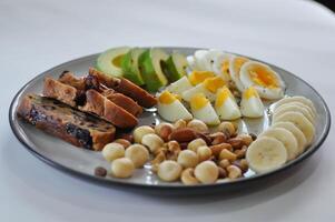 walnut cranberry sourdough bread or cranberry sourdough with boiled egg , avocado , banana and nuts photo